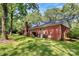 Back of house with brick exterior and green lawn at 1801 Windsor Dr, Lancaster, SC 29720