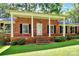 Brick ranch house with a covered porch and landscaped yard at 1801 Windsor Dr, Lancaster, SC 29720