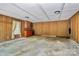 Unfinished garage with wood paneling and concrete floor at 1801 Windsor Dr, Lancaster, SC 29720