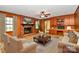 Living room with wood-paneled walls, fireplace, and built-in shelving at 1801 Windsor Dr, Lancaster, SC 29720