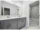 Bathroom with marble tile, a double sink vanity and a view of the shower and toilet at 133 Jentri Way, Mooresville, NC 28115