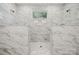 Walk-in shower with marble-look tile and a window at 133 Jentri Way, Mooresville, NC 28115