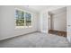 Serene bedroom featuring soft carpet, a bright window with outdoor views, and an inviting ambiance at 133 Jentri Way, Mooresville, NC 28115
