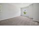 Bedroom with neutral carpeting and paint and a large window that provides lots of natural light at 133 Jentri Way, Mooresville, NC 28115
