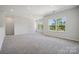 Bright, open bonus room featuring neutral paint, plush carpeting, and large windows providing lots of natural light at 133 Jentri Way, Mooresville, NC 28115