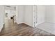 Bright hallway with wood flooring, white trim, and a view into the living room with a fireplace at 133 Jentri Way, Mooresville, NC 28115