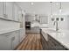 Modern kitchen with gray cabinets, stainless steel appliances, a farmhouse sink, and a stylish island at 133 Jentri Way, Mooresville, NC 28115