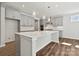 Contemporary kitchen featuring gray cabinets, a spacious island with a sink, and modern pendant lighting at 133 Jentri Way, Mooresville, NC 28115