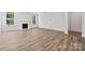 Spacious living room with elegant wood floors, a classic fireplace, and abundant natural light from multiple windows at 133 Jentri Way, Mooresville, NC 28115