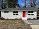 Charming white brick ranch home with red door and landscaping at 2600 Alleghany St, Charlotte, NC 28208