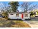 Charming ranch home with a red door and well-manicured lawn at 2600 Alleghany St, Charlotte, NC 28208