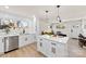 Open concept kitchen with white cabinets and island at 2600 Alleghany St, Charlotte, NC 28208