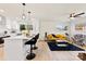 Open concept living area with white kitchen and yellow couch at 2600 Alleghany St, Charlotte, NC 28208