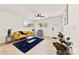 Light-filled living room featuring a mustard sofa and blue rug at 2600 Alleghany St, Charlotte, NC 28208