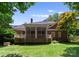 Expansive backyard featuring a brick home with a screened porch and lush green lawn at 4301 Fairview Oaks Dr, Charlotte, NC 28211