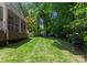 Lush green backyard with well-maintained lawn and mature trees, creating a private outdoor space at 4301 Fairview Oaks Dr, Charlotte, NC 28211