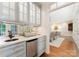 Chic bar area featuring custom cabinetry, granite countertops, and a beverage refrigerator for entertaining guests at 4301 Fairview Oaks Dr, Charlotte, NC 28211