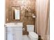 Small bathroom with patterned wallpaper and white vanity at 4301 Fairview Oaks Dr, Charlotte, NC 28211