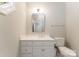 Clean bathroom with a white vanity, toilet, and a framed mirror at 4301 Fairview Oaks Dr, Charlotte, NC 28211