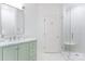 Bright bathroom featuring a marble-topped green vanity and a modern glass-enclosed shower with white subway tile at 4301 Fairview Oaks Dr, Charlotte, NC 28211