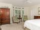 Spacious bedroom with sitting area, hardwood floors, and large window at 4301 Fairview Oaks Dr, Charlotte, NC 28211