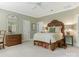 Bedroom with antique bed, dresser, and green walls at 4301 Fairview Oaks Dr, Charlotte, NC 28211