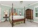 Bedroom with a wooden four-poster bed and dresser at 4301 Fairview Oaks Dr, Charlotte, NC 28211