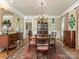 Formal dining room with large table, chandelier and hardwood floors at 4301 Fairview Oaks Dr, Charlotte, NC 28211