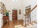 Spacious entryway with hardwood floors, staircase, and decorative artwork at 4301 Fairview Oaks Dr, Charlotte, NC 28211