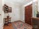 Entryway with hardwood floors, area rug and built-in cabinet at 4301 Fairview Oaks Dr, Charlotte, NC 28211