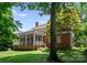 Back of home featuring a screened-in porch and a well-maintained lawn at 4301 Fairview Oaks Dr, Charlotte, NC 28211