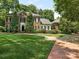 Brick two-story house with landscaped lawn and brick walkway at 4301 Fairview Oaks Dr, Charlotte, NC 28211