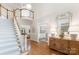 Elegant foyer with a grand staircase, light hardwood floors, and stylish decor at 4301 Fairview Oaks Dr, Charlotte, NC 28211