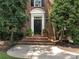 Elegant front entry with black door and brick steps at 4301 Fairview Oaks Dr, Charlotte, NC 28211