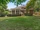 Brick house with screened porch and large backyard at 4301 Fairview Oaks Dr, Charlotte, NC 28211