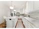 Elegant kitchen with custom white cabinets, granite countertops, tiled backsplash, and hardwood flooring at 4301 Fairview Oaks Dr, Charlotte, NC 28211