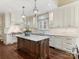 Spacious kitchen with white cabinets, granite countertops and large island at 4301 Fairview Oaks Dr, Charlotte, NC 28211