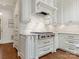 Bright kitchen with white cabinets, stone backsplash, and red range at 4301 Fairview Oaks Dr, Charlotte, NC 28211