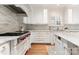 Modern kitchen showcasing white cabinetry, a professional-grade range, and beautiful countertops for cooking enthusiasts at 4301 Fairview Oaks Dr, Charlotte, NC 28211