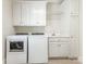 Laundry room with white cabinets, washer, and dryer at 4301 Fairview Oaks Dr, Charlotte, NC 28211