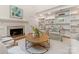Spacious living room featuring built-in shelving, a fireplace, and hardwood floors at 4301 Fairview Oaks Dr, Charlotte, NC 28211