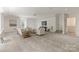 Bright living room with neutral decor, plush seating, and a ceiling fan, perfect for relaxing and entertaining at 4301 Fairview Oaks Dr, Charlotte, NC 28211