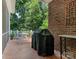 Brick patio with grill and outdoor seating area at 4301 Fairview Oaks Dr, Charlotte, NC 28211