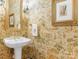 Stylish powder room with pedestal sink and patterned wallpaper at 4301 Fairview Oaks Dr, Charlotte, NC 28211