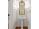 Charming powder room with pedestal sink, ornate gold mirror, and sconce lighting, enhanced by elegant trim at 4301 Fairview Oaks Dr, Charlotte, NC 28211