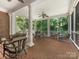 Large screened porch with brick flooring and seating at 4301 Fairview Oaks Dr, Charlotte, NC 28211
