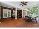 Spacious screened porch with brick floor, seating, and outdoor dining area at 4301 Fairview Oaks Dr, Charlotte, NC 28211