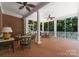 Inviting screened porch with brick flooring, white pillars, and comfortable seating at 4301 Fairview Oaks Dr, Charlotte, NC 28211