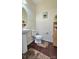 A half bathroom featuring a pedestal sink, toilet, and wood-style flooring at 11521 Allen A Brown Rd, Charlotte, NC 28269