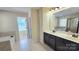 Bathroom with dual vanity and a doorway leading to a commode and shower area at 11521 Allen A Brown Rd, Charlotte, NC 28269